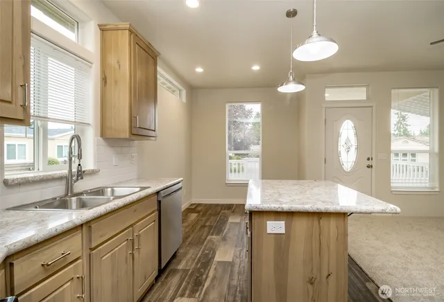 a kitchen with granite countertop cabinets and window
