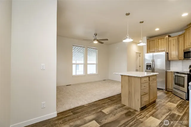 a kitchen with kitchen island a sink appliances and cabinets