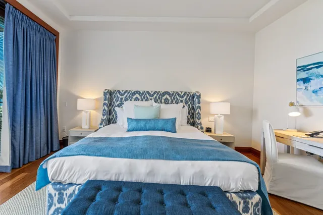 a bed sitting in a bedroom next to a wooden floor