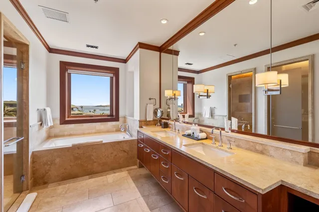a spacious bathroom with a double vanity sink and a large mirror
