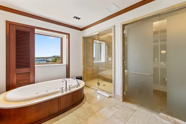 a bedroom with two beds and painting on the wall