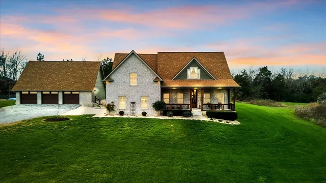 a front view of a house with a garden and deck