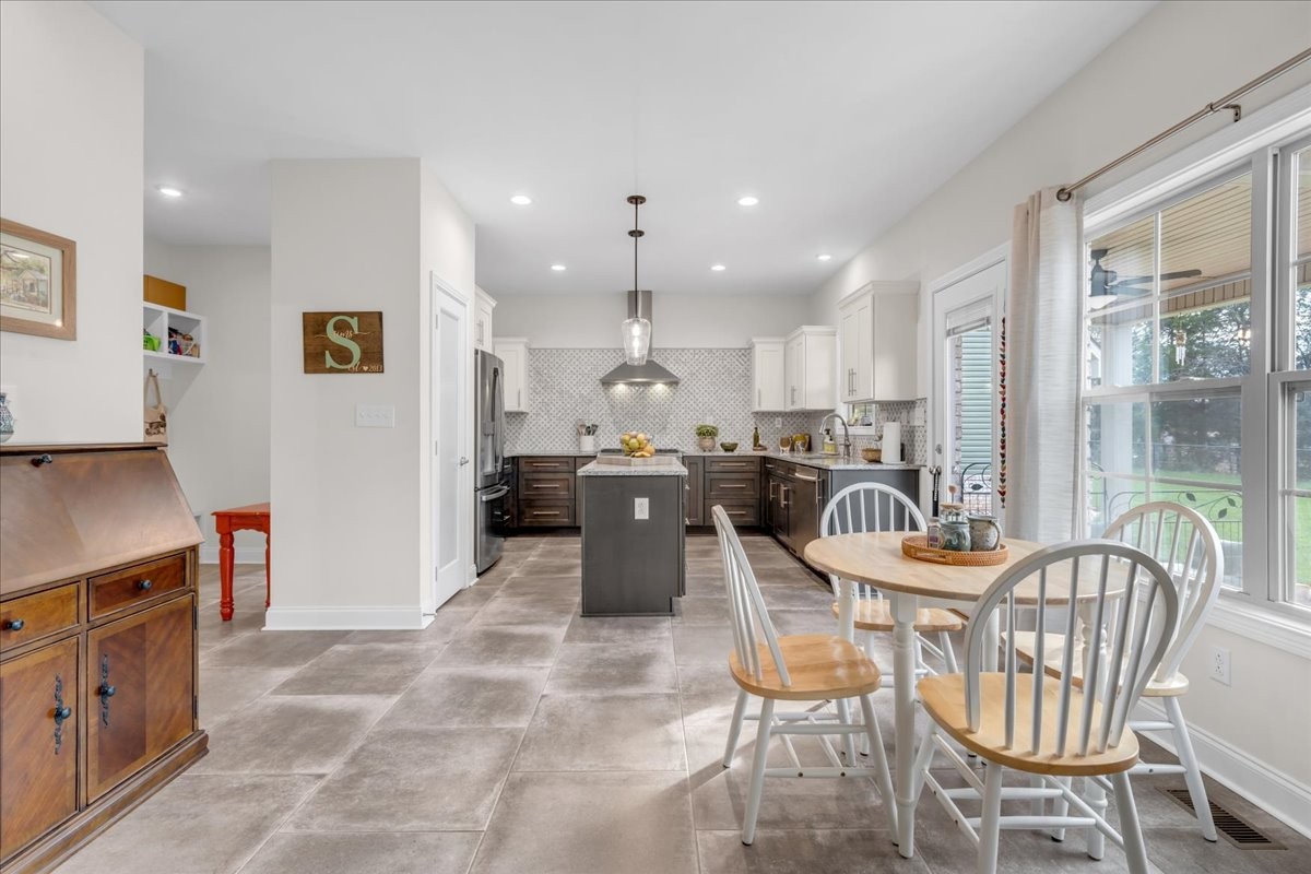 3512 Ashland City Road Clarksville, TN 37043 - Photo 14 of 58 a kitchen with a dining table chairs and refrigerator