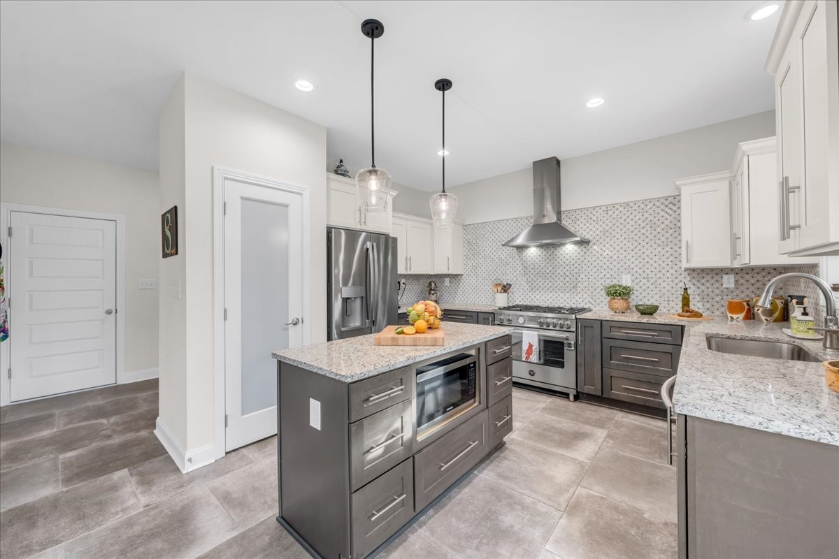 3512 Ashland City Road Clarksville, TN 37043 - Photo 19 of 58 a kitchen with stainless steel appliances granite countertop a stove a sink a refrigerator and a wooden cabinets