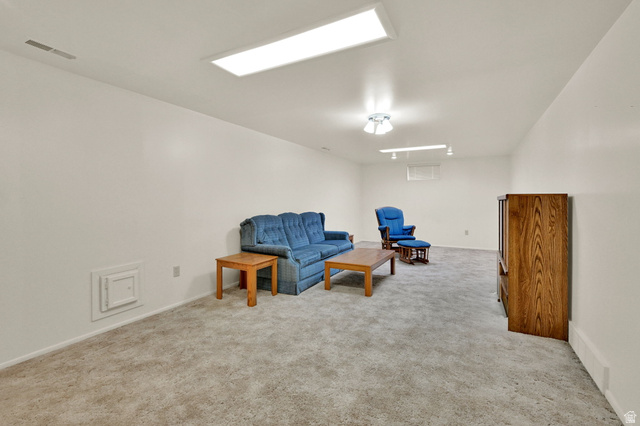 2467 South 2000 West Syracuse, UT 84075 - Photo 19 of 28 Spacious room featuring light gray carpeting, white walls, and bright overhead lighting