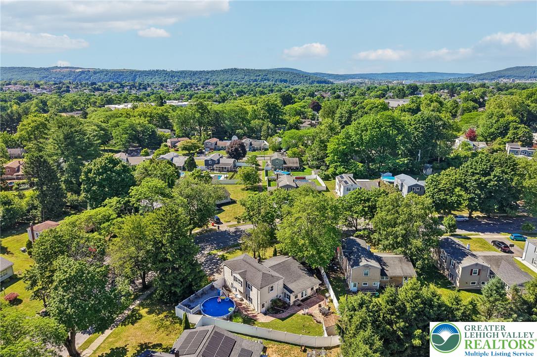 2649 Nottingham Road Bethlehem, PA 18017 - Photo 43 of 49 An aerial panorama showcases a suburban neighborhood nestled amongst mature trees and distant hills.
