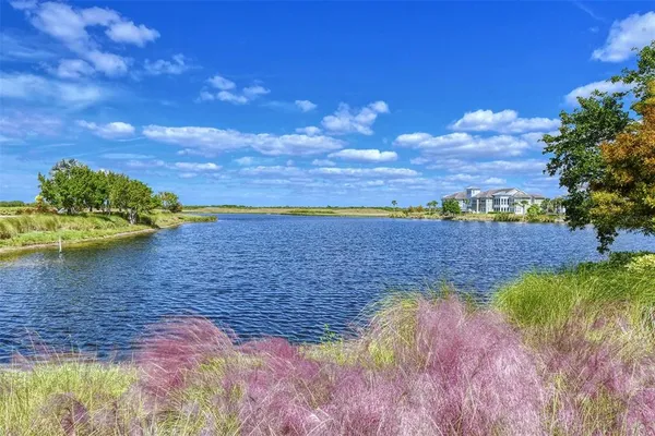 a front view of a house with a yard and outdoor seating
