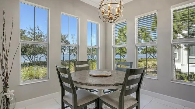a bedroom with bed and a couch next to a window