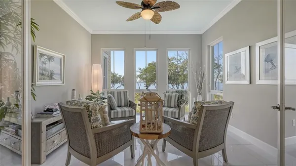 a bedroom with a bed a dresser and a large mirror next to a window