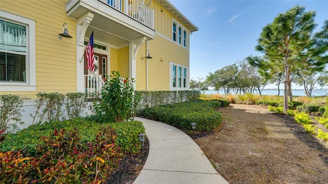 a view of a hallway with wooden floor and a potted plant