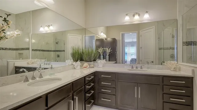 a large bed sitting in a bedroom next to a window