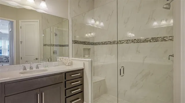 a bedroom with a bed and a mirror on dresser