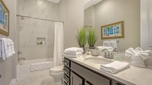 front view of a house with a yard and palm trees