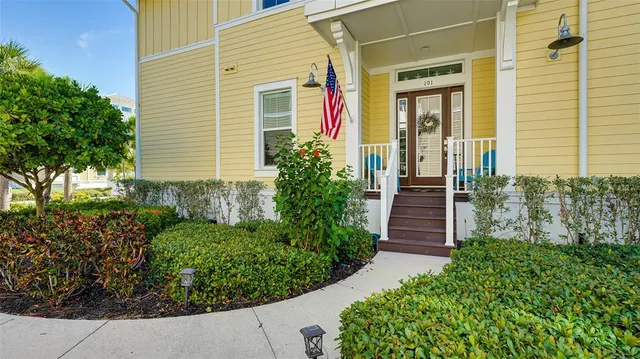 a living room with furniture kitchen and a chandelier