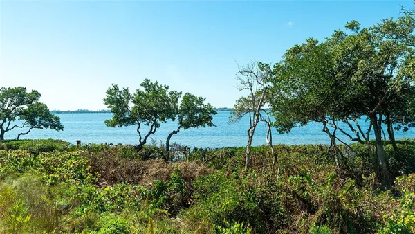 a view of a lake with a table and chairs