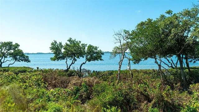a view of a lake with a table and chairs