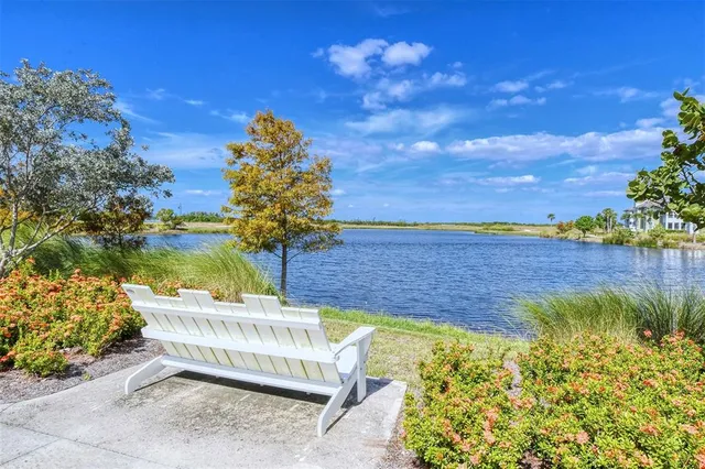 a view of ocean with boats and trees in the background