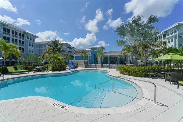 a view of a house with yard and lake view