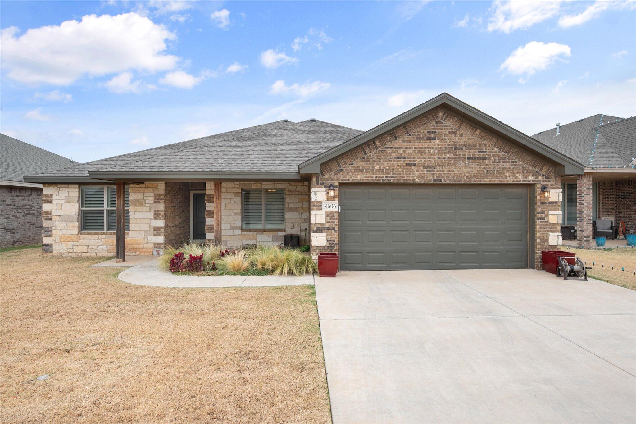 9606 Hope Avenue Lubbock, TX 79424 - Photo 2 of 35 a front view of house with yard outdoor seating and barbeque oven
