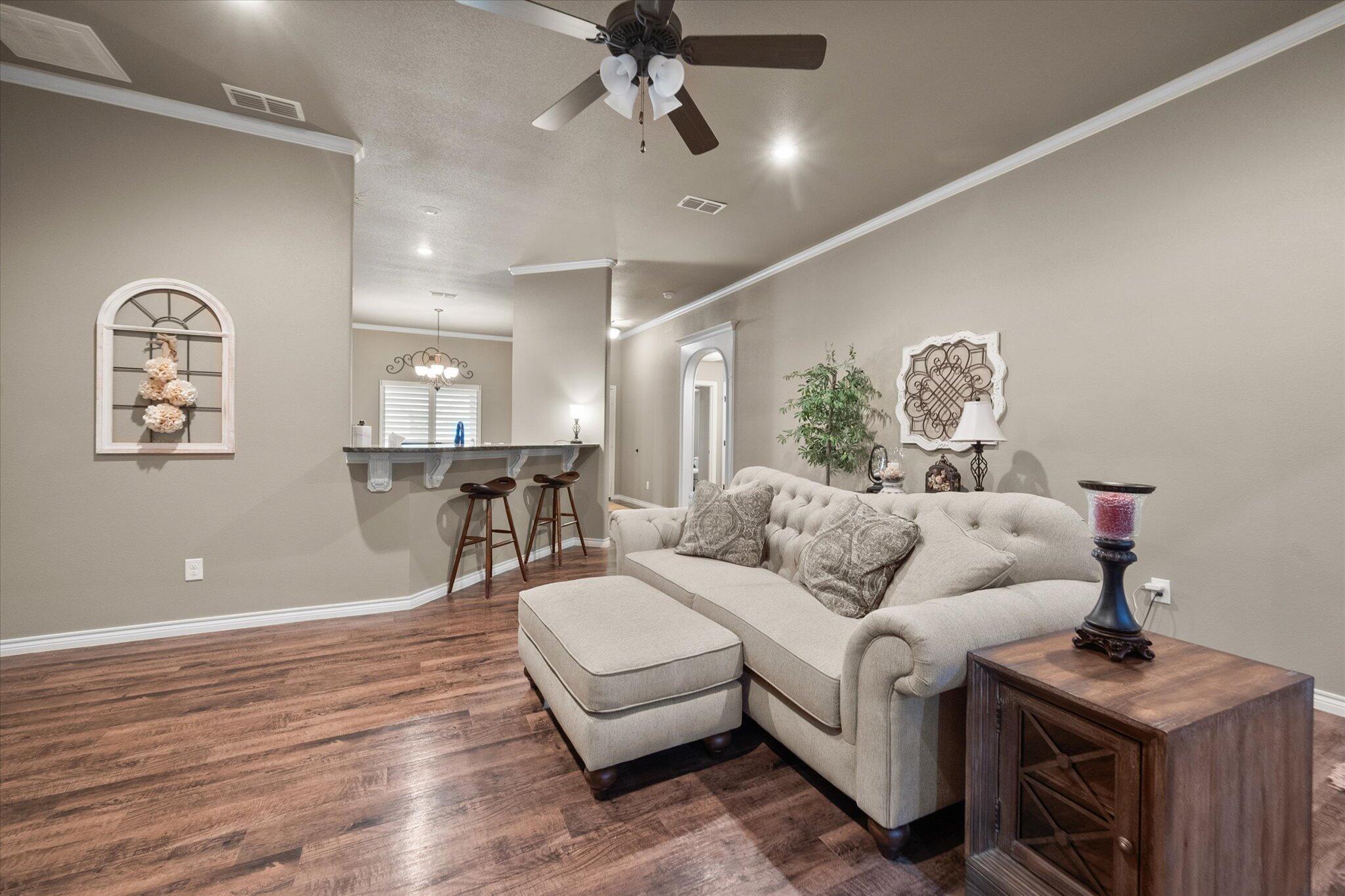 9606 Hope Avenue Lubbock, TX 79424 - Photo 21 of 35 a living room with furniture and a wooden floor