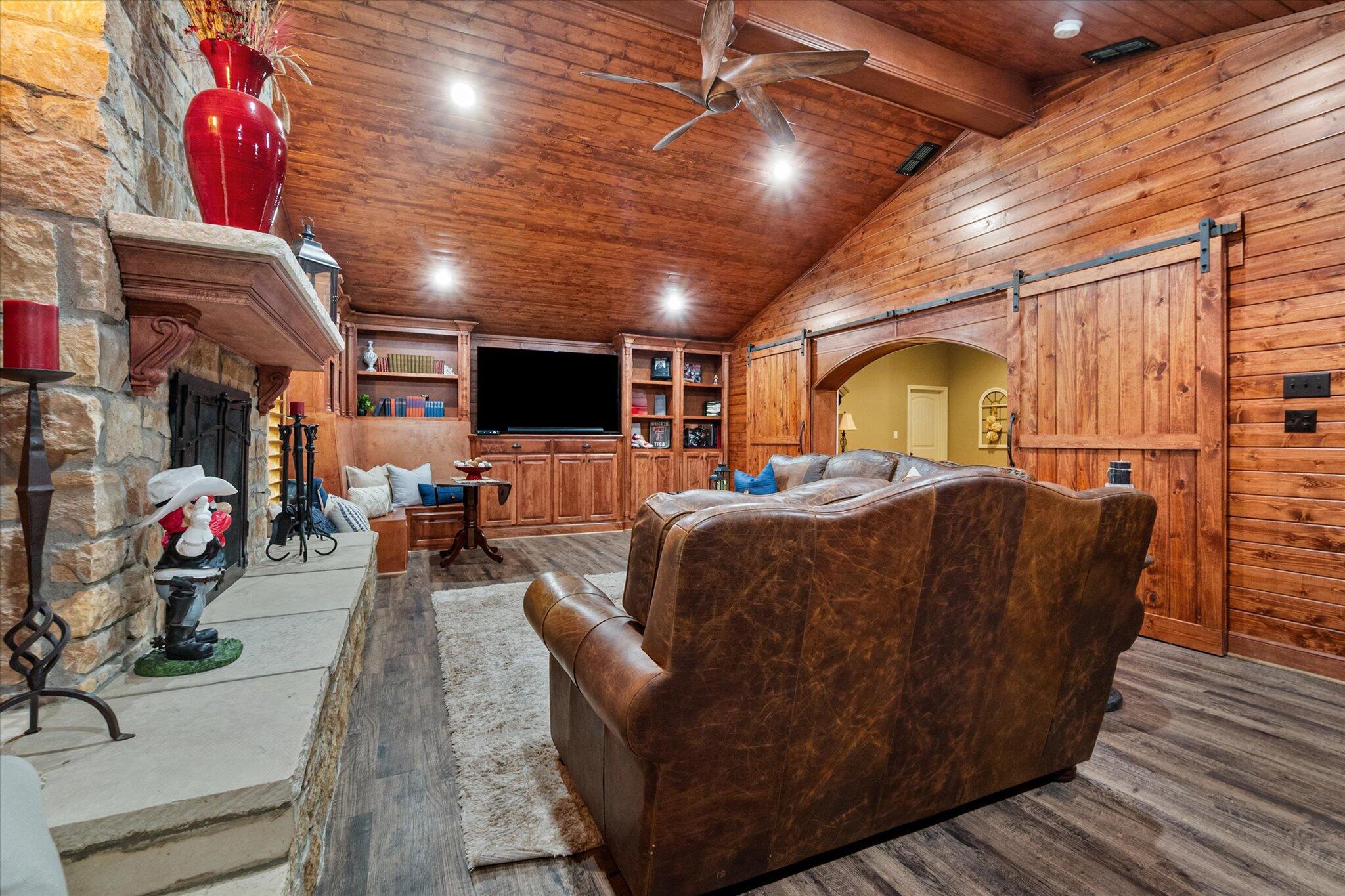 9606 Hope Avenue Lubbock, TX 79424 - Photo 24 of 35 a living room with furniture and a flat screen tv