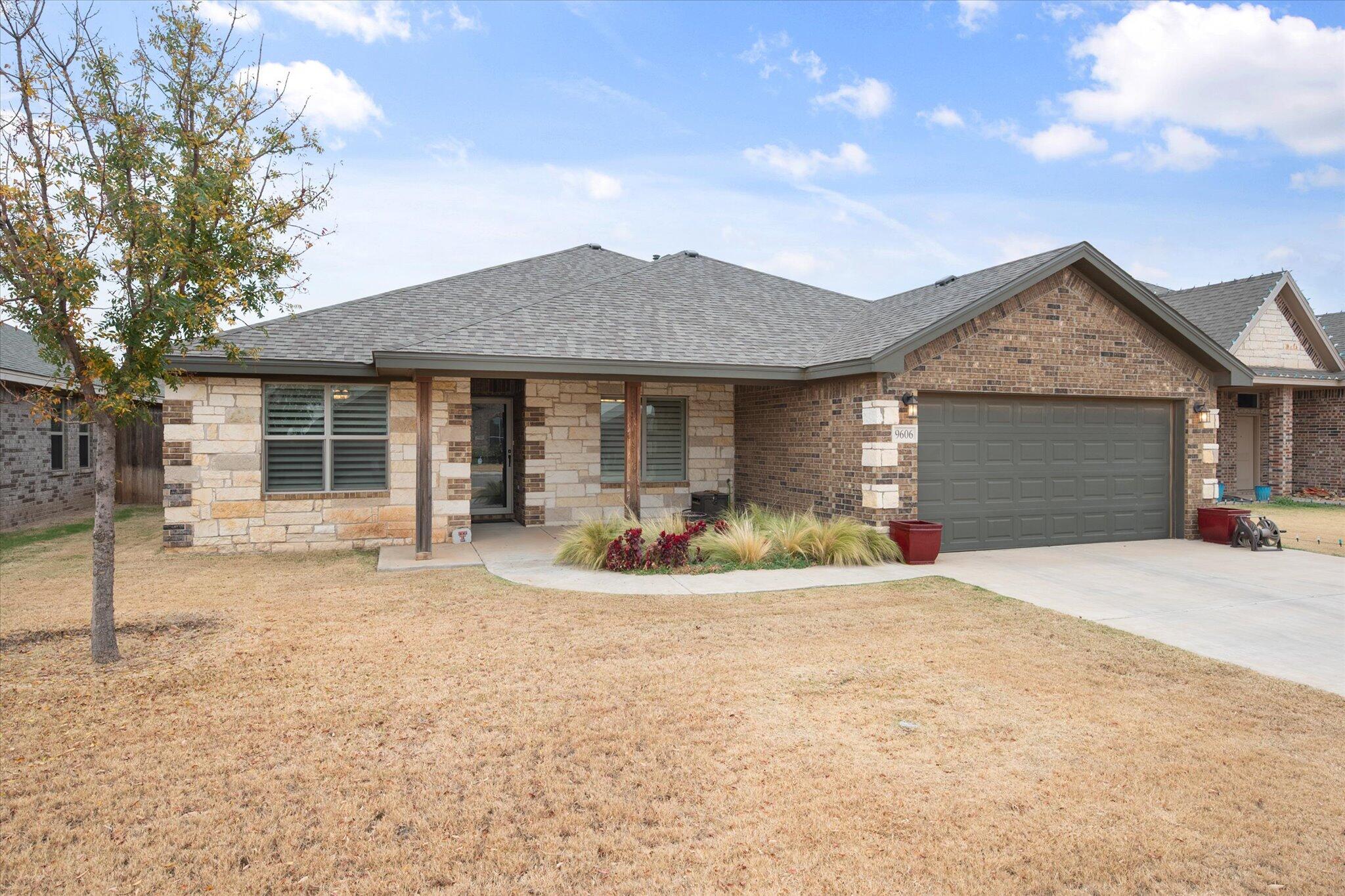 9606 Hope Avenue Lubbock, TX 79424 - Photo 3 of 35 a front view of a house with yard outdoor seating and barbeque oven