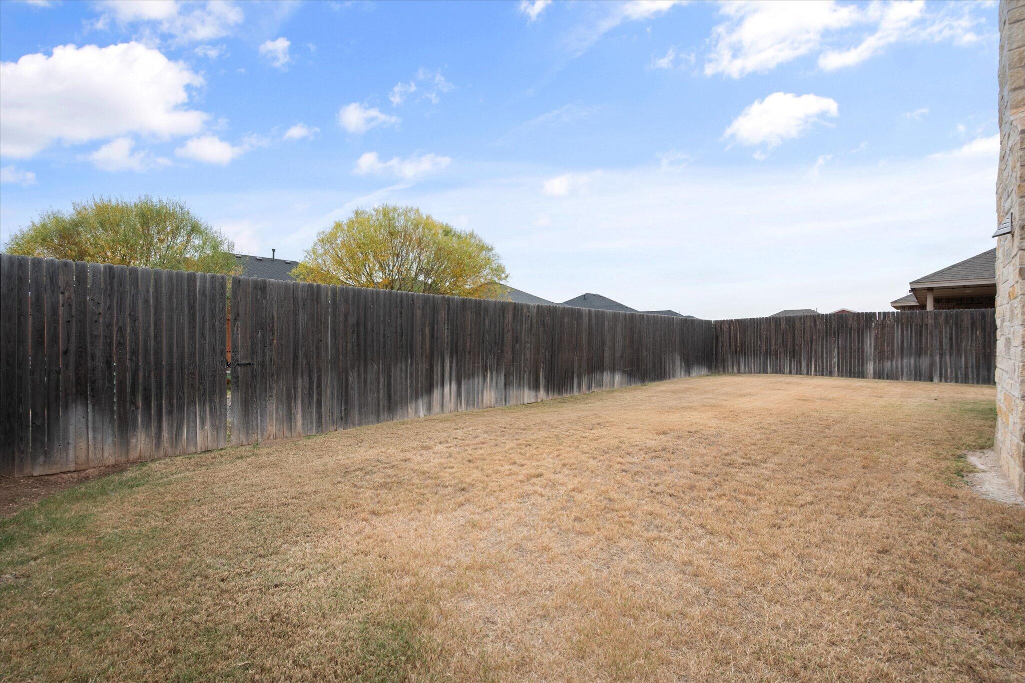 9606 Hope Avenue Lubbock, TX 79424 - Photo 35 of 35 a backyard of a house with lots of green space