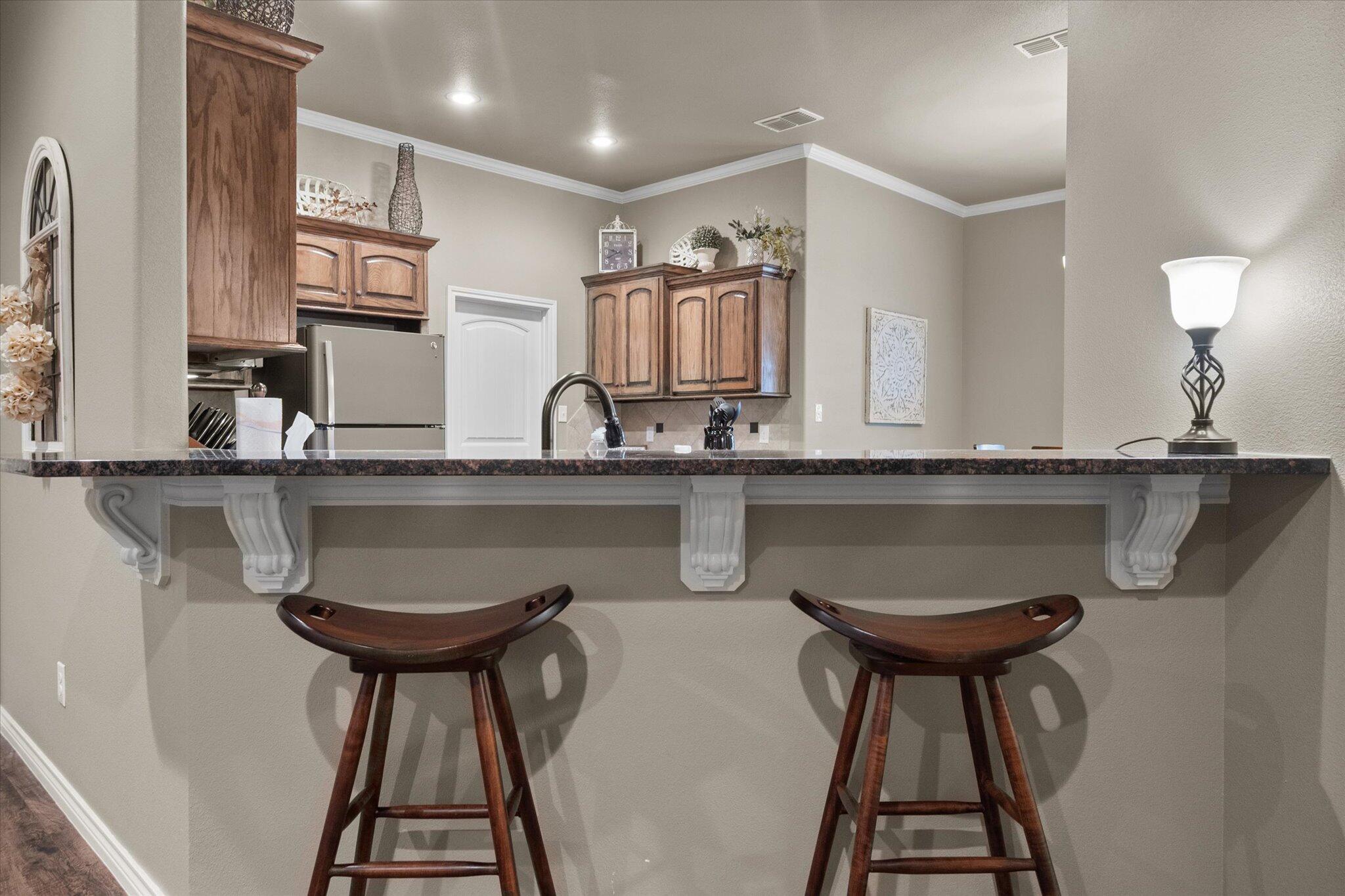 9606 Hope Avenue Lubbock, TX 79424 - Photo 9 of 35 a kitchen with stainless steel appliances a sink and a refrigerator