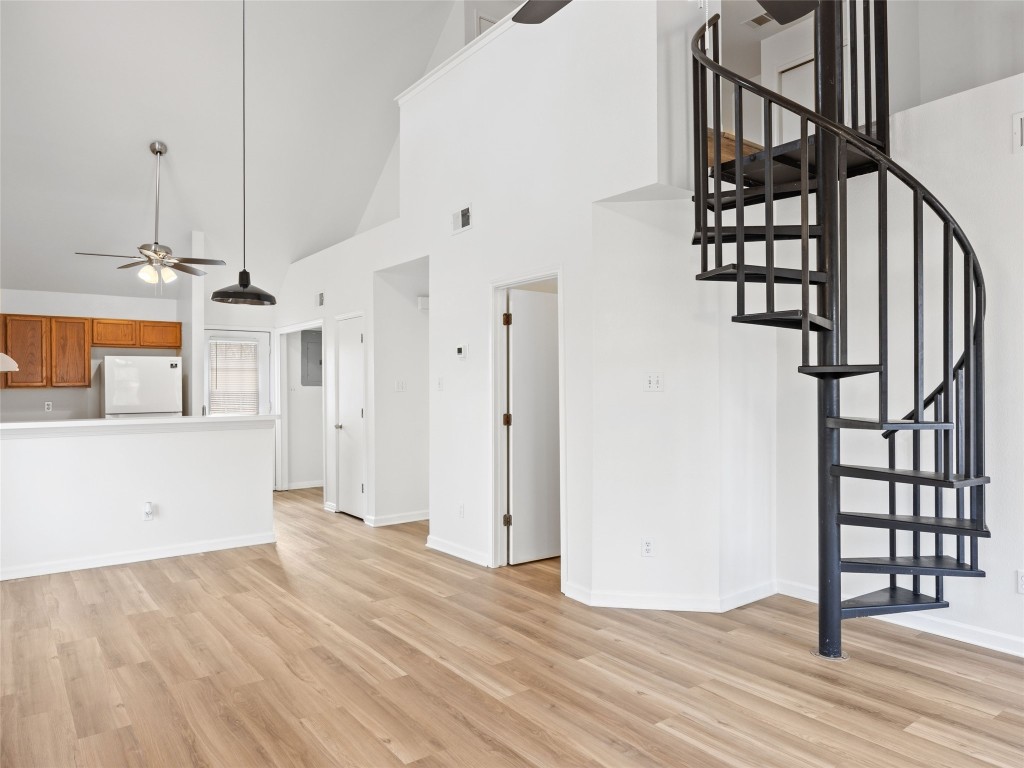2908 Whisper Oaks Lane Georgetown, TX 78628 - Photo 11 of 32 a view of a livingroom with wooden floor and stairs
