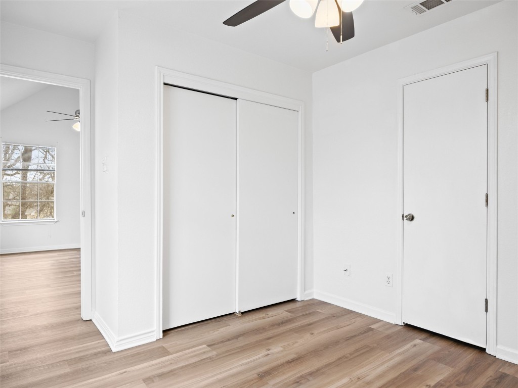 2908 Whisper Oaks Lane Georgetown, TX 78628 - Photo 21 of 32 a view of an empty room with wooden floor