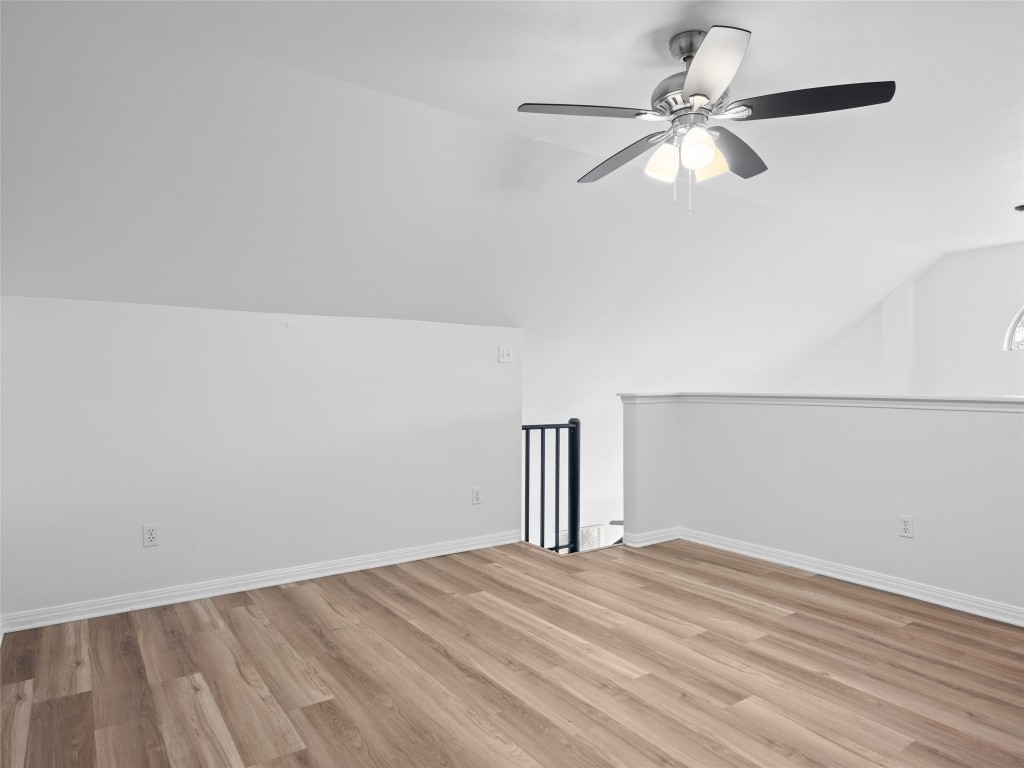 2908 Whisper Oaks Lane Georgetown, TX 78628 - Photo 28 of 32 Bonus room with lofted ceiling, light wood-style flooring, and ceiling fan