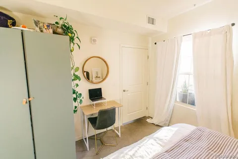 a bedroom with furniture and a wooden floor