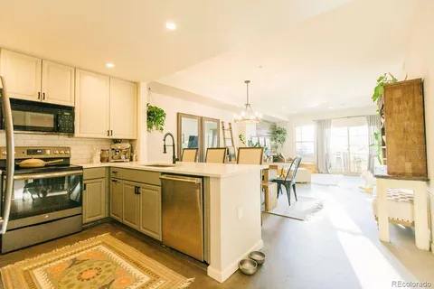 a kitchen with stainless steel appliances granite countertop a stove and a refrigerator