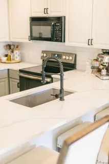 a kitchen with stainless steel appliances a stove sink and cabinets