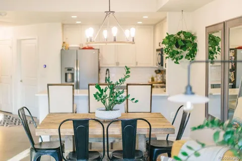 a kitchen with stainless steel appliances kitchen island granite countertop a refrigerator and a stove top oven