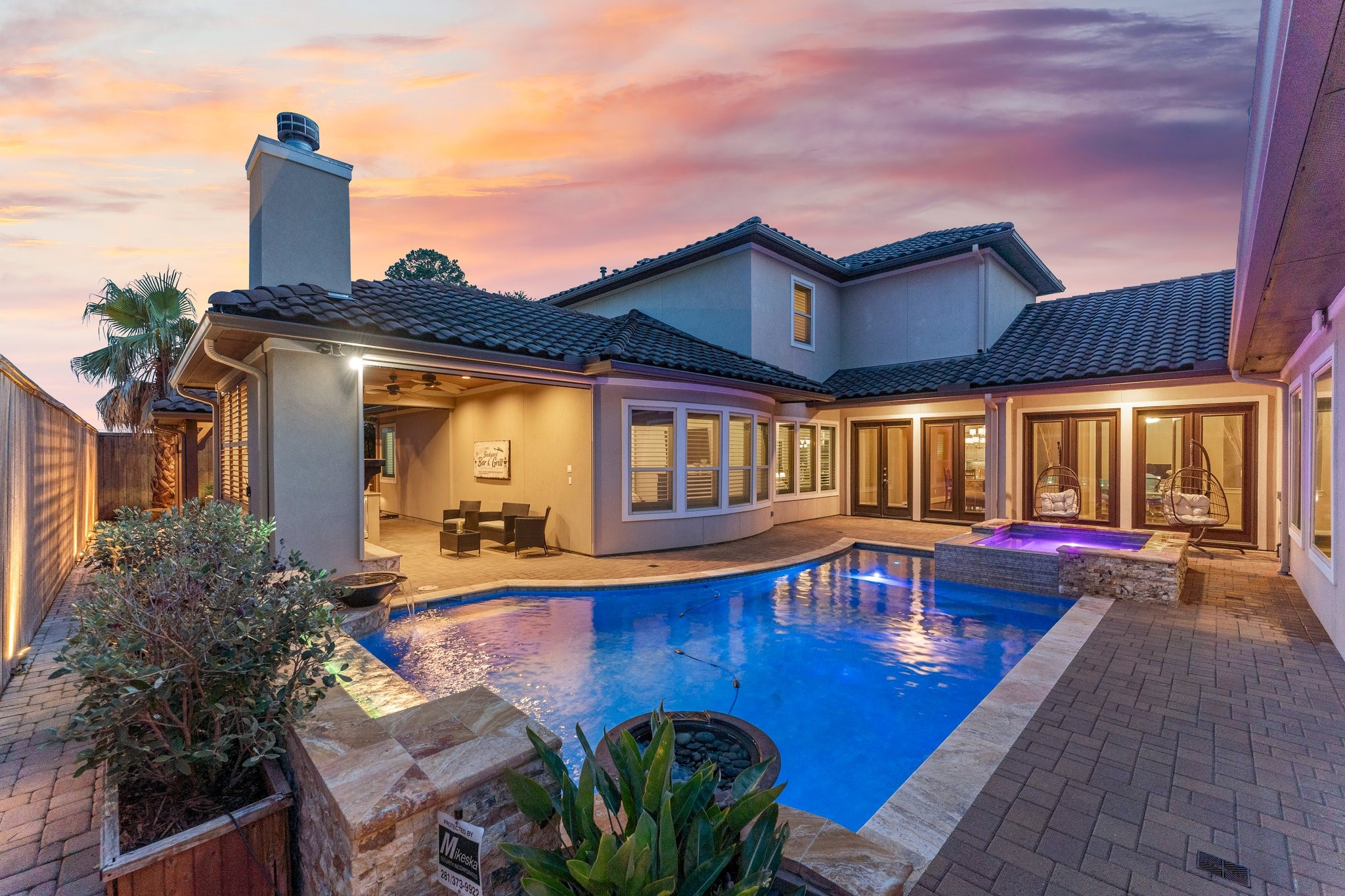 a view of a house with pool and chairs