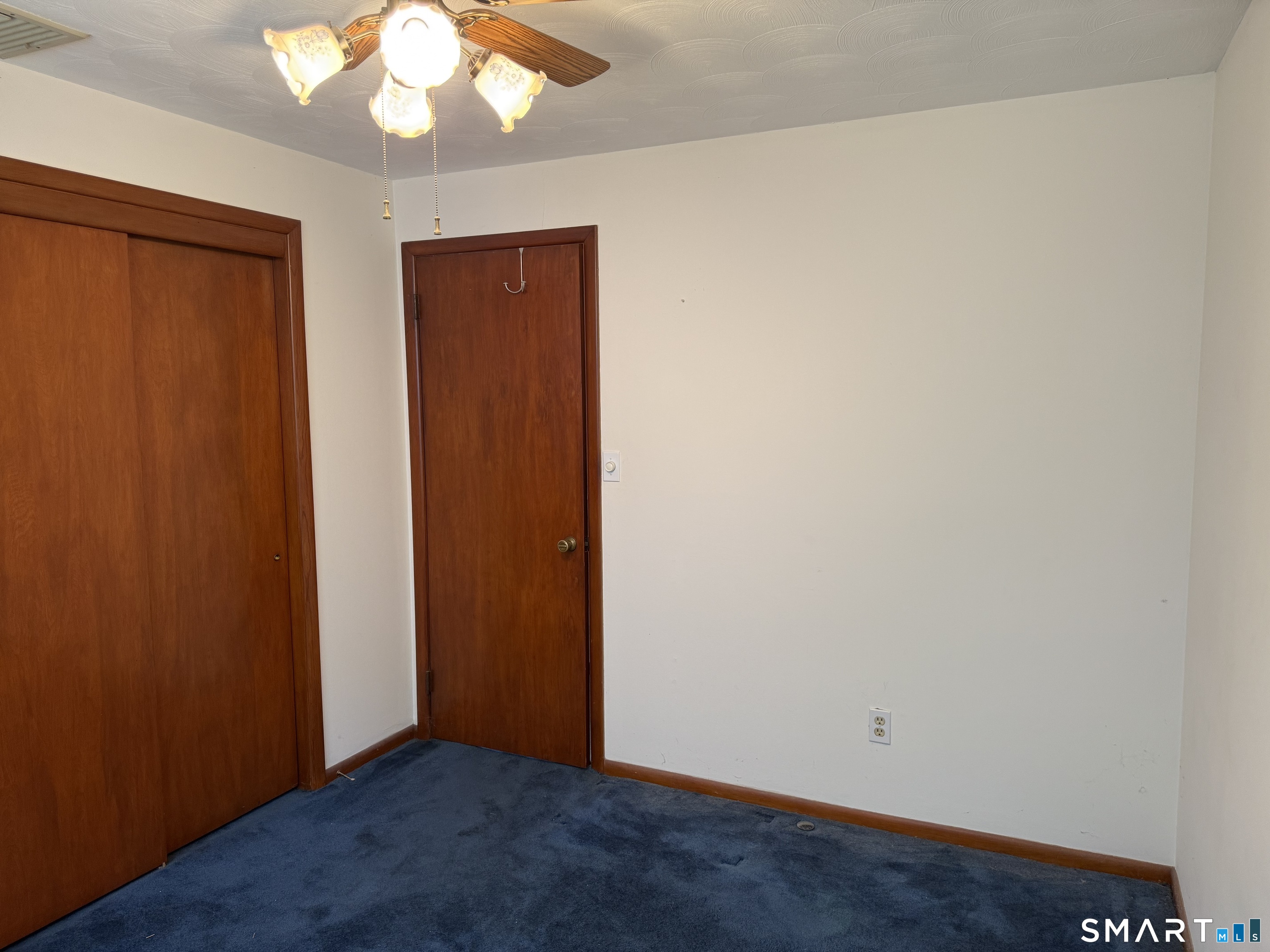 26 Maple Street Trumbull, CT 06611 - Photo 27 of 37 an empty room with wooden floor and windows