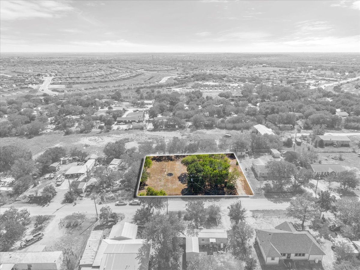 Aerial view of property and surrounding area featuring property boundaries highlighted