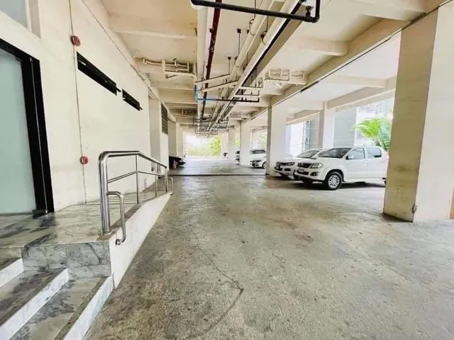 a room with a bed and a view of living room