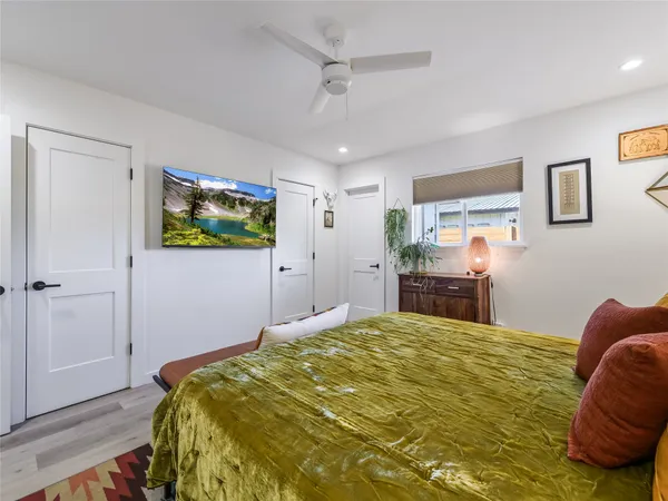 a bedroom with a bed and a flat screen tv