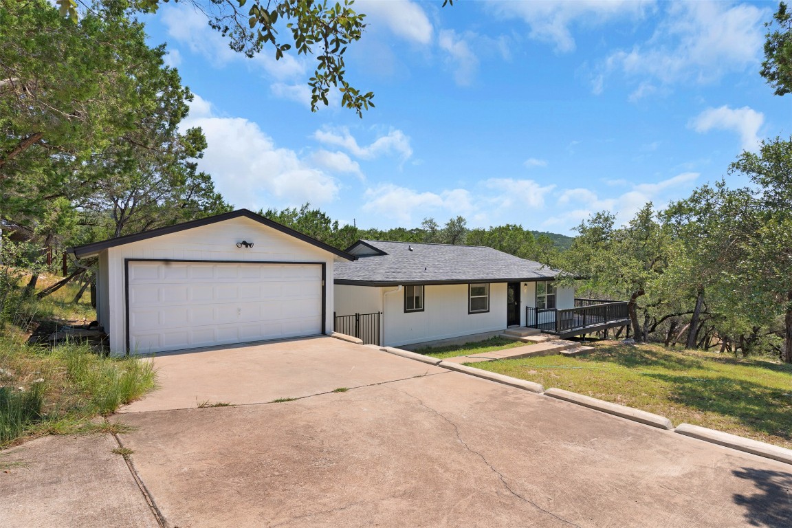 21009 Buena Vista Lago Vista, TX 78645 - Photo 1 of 1 a front view of a house with yard and green space