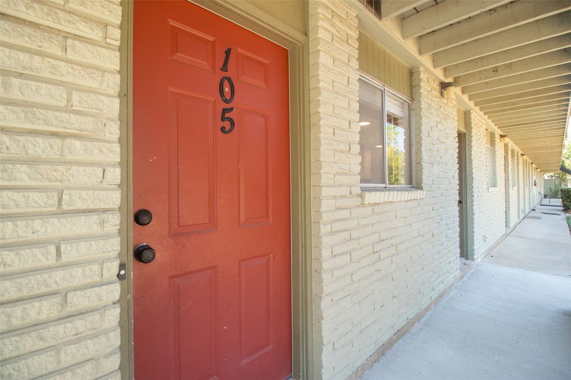 806 East 13th Street, Unit 105 Georgetown, TX 78626 - Photo 12 of 25 Doorway to property with covered porch and brick siding