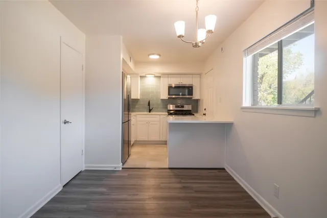 a kitchen with a refrigerator and cabinets