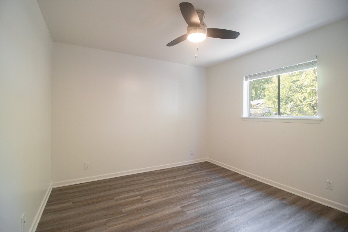 806 East 13th Street, Unit 105 Georgetown, TX 78626 - Photo 21 of 25 an empty room with wooden floor and windows