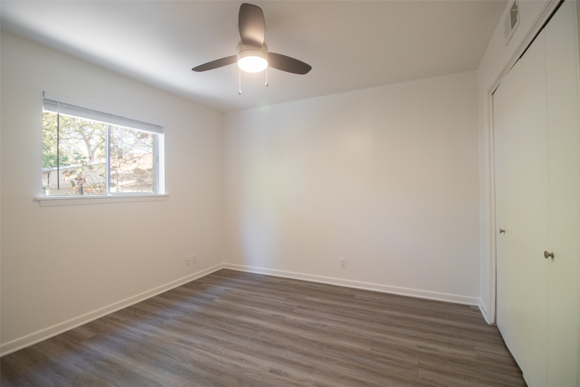 806 East 13th Street, Unit 105 Georgetown, TX 78626 - Photo 23 of 25 wooden floor in an empty room with a window