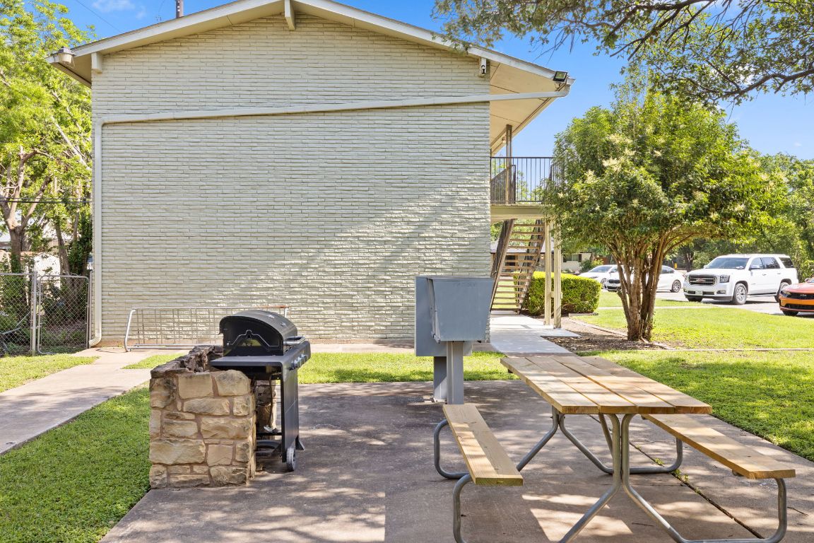 806 East 13th Street, Unit 105 Georgetown, TX 78626 - Photo 6 of 25 a view of a patio with a table and chairs and potted plants