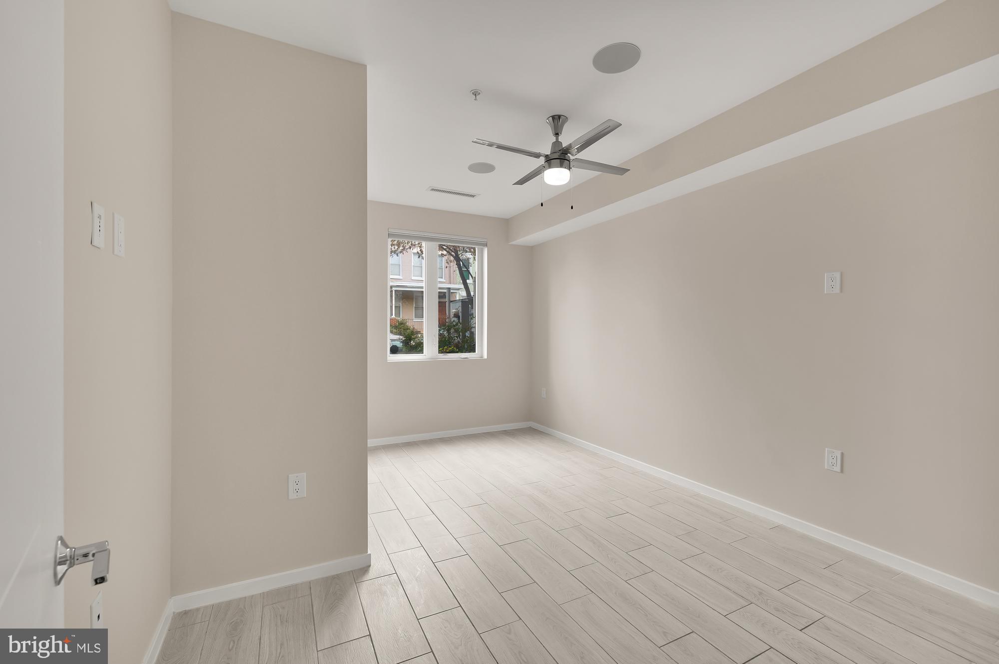 756 Park Road Northwest, Unit 1 Washington, DC 20010 - Photo 11 of 25 an empty room with windows and fan