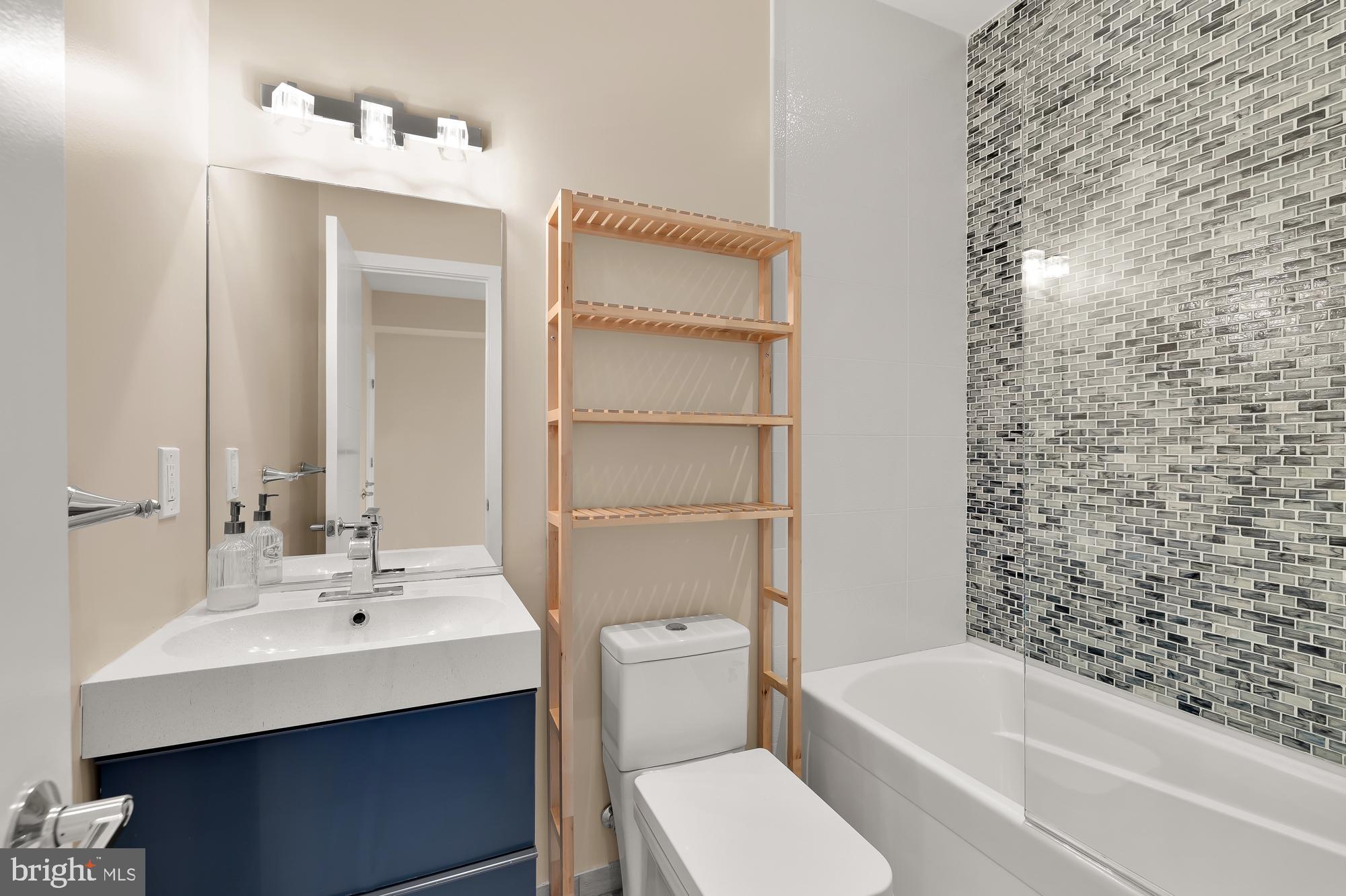 756 Park Road Northwest, Unit 1 Washington, DC 20010 - Photo 16 of 25 a bathroom with a sink a toilet and shower