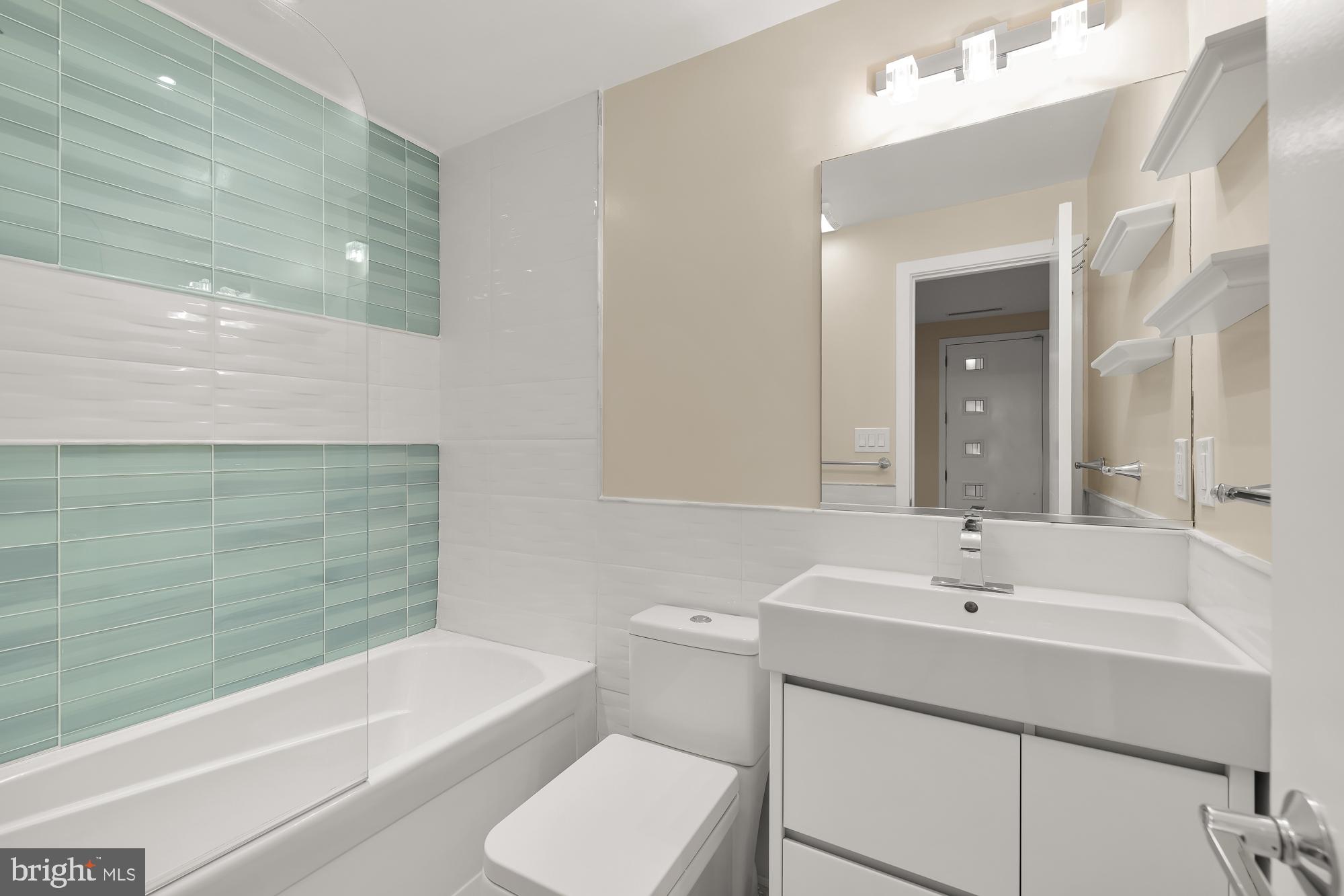 756 Park Road Northwest, Unit 1 Washington, DC 20010 - Photo 24 of 25 a bathroom with a sink a toilet and shower