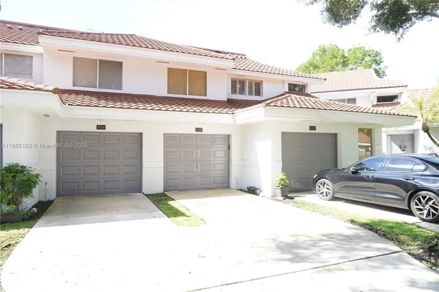 a view of a white house with a outdoor space